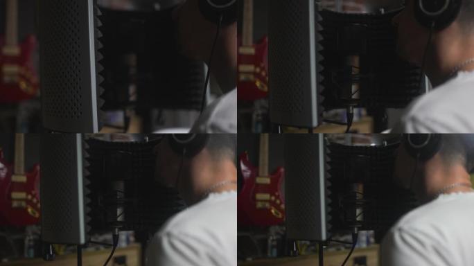 男音乐家在录音室练习时试图在麦克风上表演歌曲