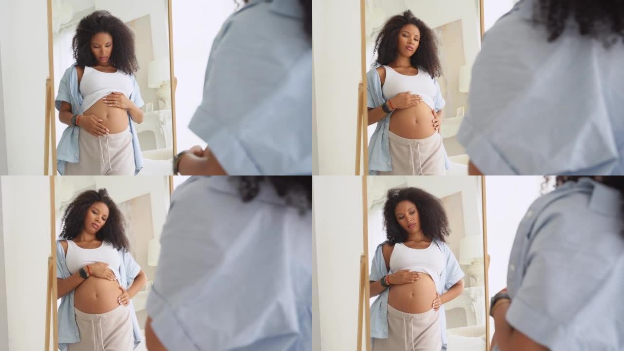 黑人孕妇不高兴，看着镜子，看到自己的体形变化。