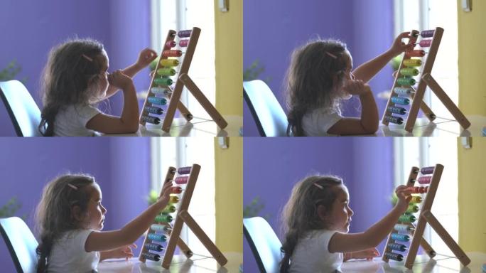 学龄前女孩使用多色木制算盘的4k视频