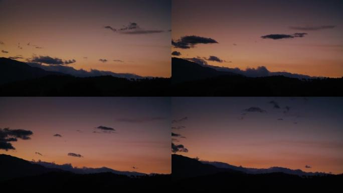 日落时分，乌云笼罩在山上的轮廓上