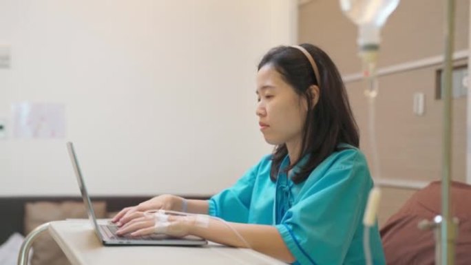 Asia patient woman sitting on the bed with saline 