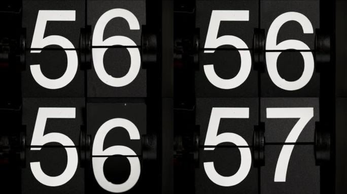 翻转时钟复古倒计时五十六白色数字变成五十七。