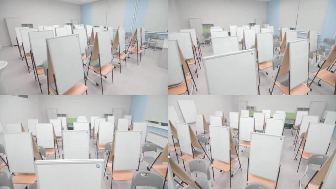 空教室中的白板折叠画架和椅子