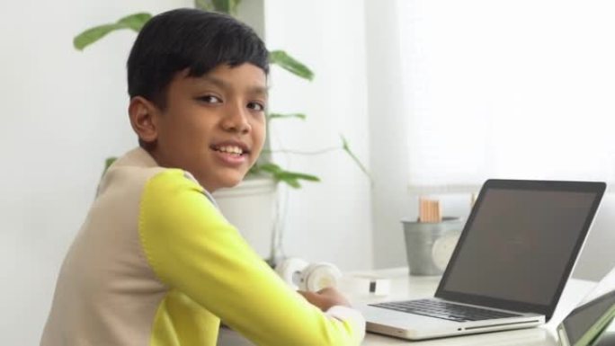 Asian boy study online with laptop