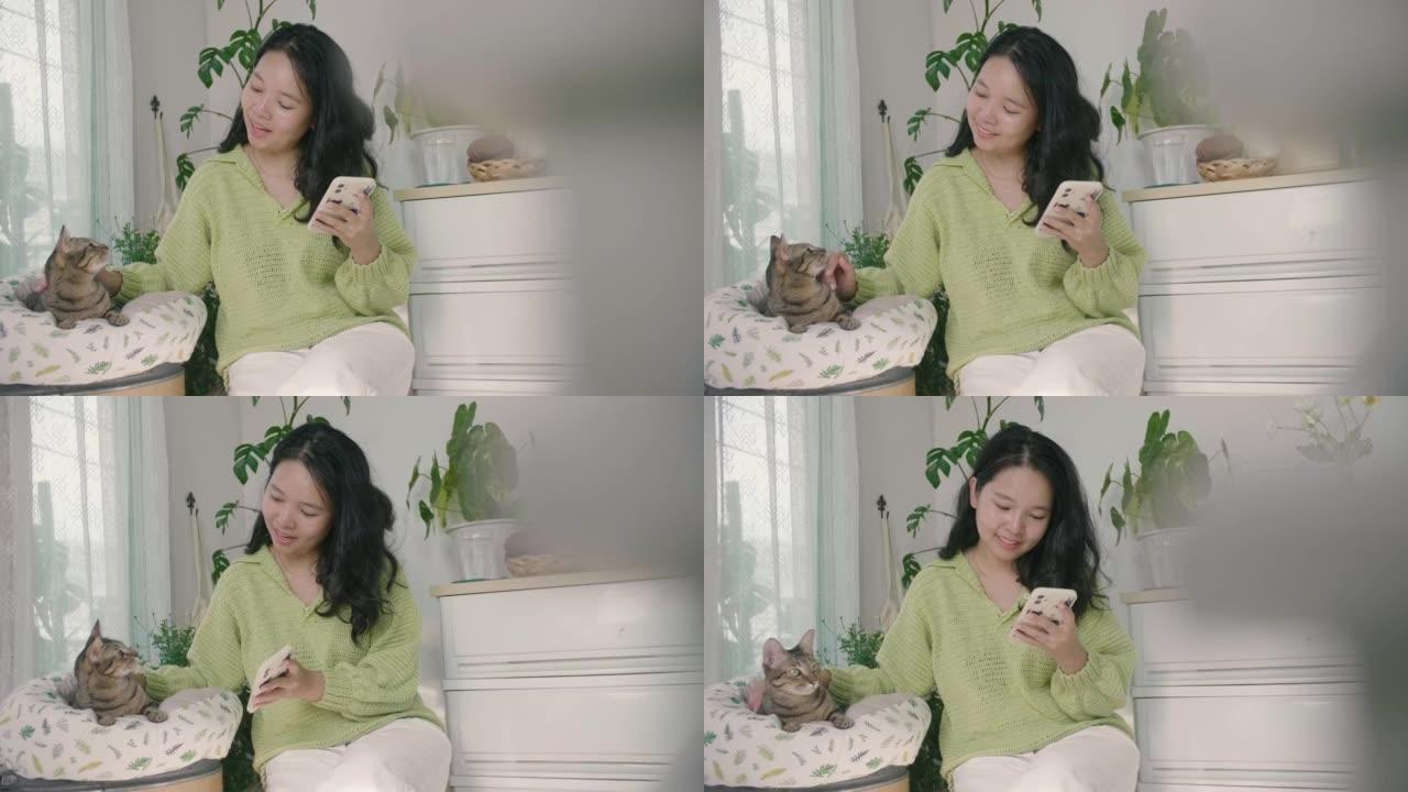 亚洲女人在使用智能手机时扮演一只可爱的猫。