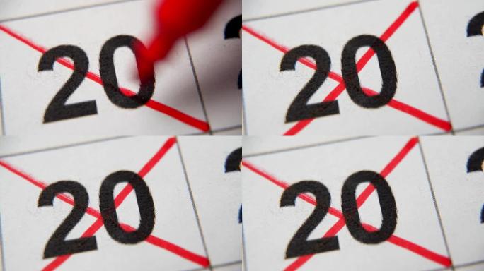 日历中的第20个数字在白纸上的宏中用红叉划掉。计划、笔记、会议日历。商业日历。日历中注释的标记。