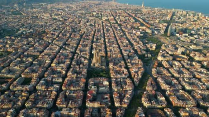 日落时鸟瞰巴塞罗那城市天际线和圣家堂大教堂。住宅著名城市网格示例。具有典型城市八角形街区的城市景观。