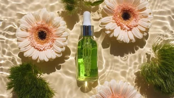 化妆品瓶上有移液管和向日葵花，非洲菊花瓣花在水面上有滴。反射阳光和阴影的水。波浪水的慢动作。广告
