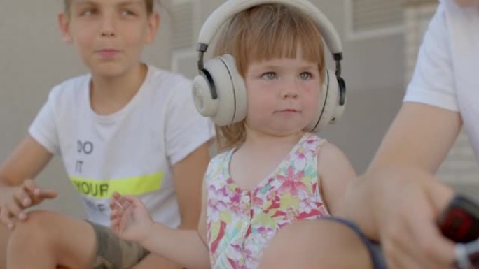 Portrait of little cute girl in headphones with br