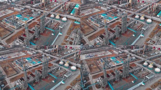 大型工业化工厂的视图，该工厂带有管道，冷却器和蒸馏塔，用于从石油生产废物和相关的石油气中生产塑料和聚