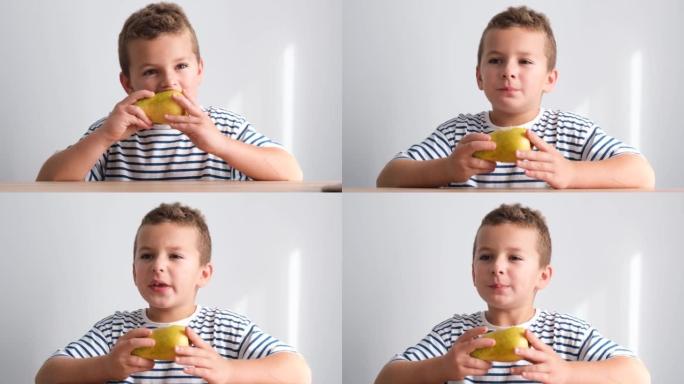 一个小男孩正在吃多汁的梨，看着相机。