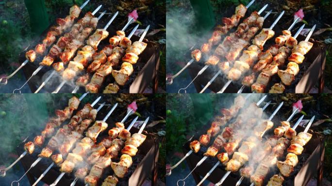 夏天，在火盆的煤上烤了刺入串肉的特写肉。在露天烹饪烤肉，在炸猪肉上抽烟。选择性聚焦