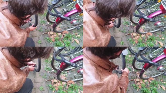 男子给自行车轮胎充气