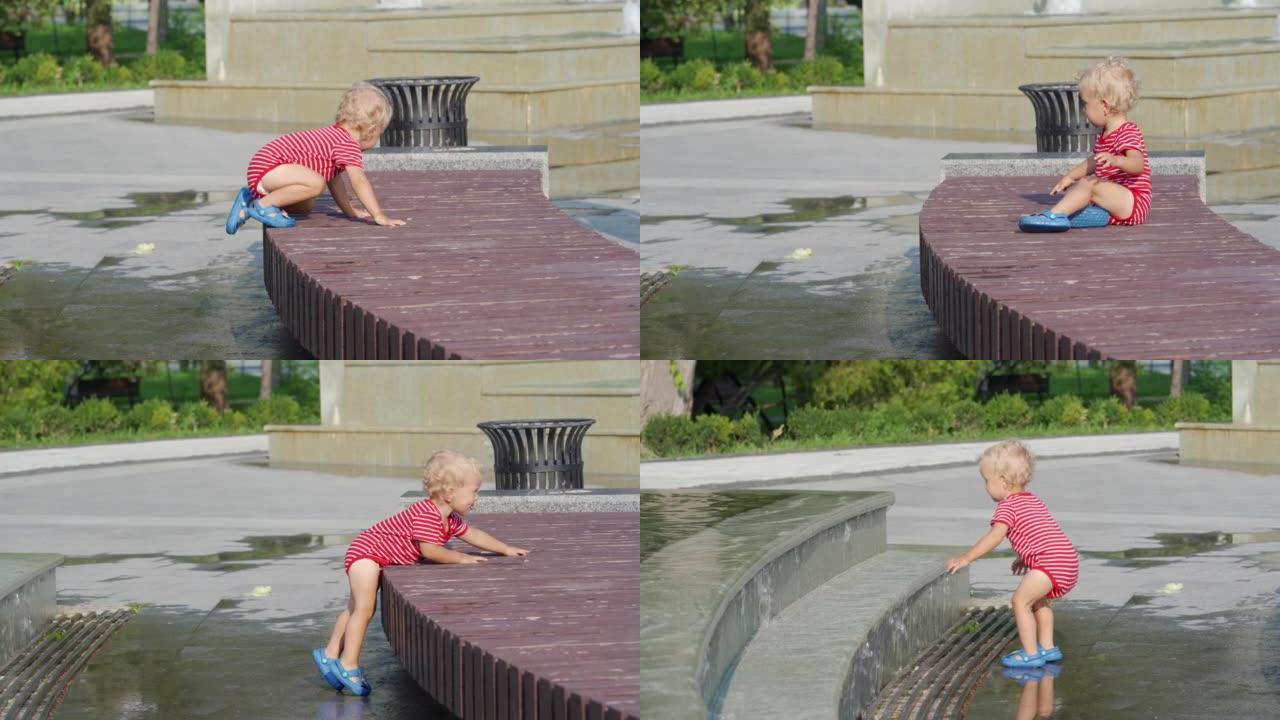 快乐的孩子在阳光明媚的夏日在公园的喷泉里玩得开心。1.5岁的孩子在热天玩喷泉水。