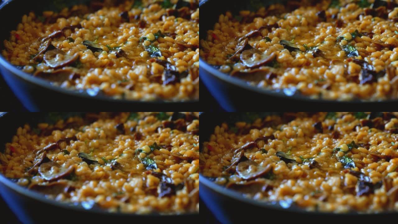 Golden orzotto with pearl barley preparing in pan.