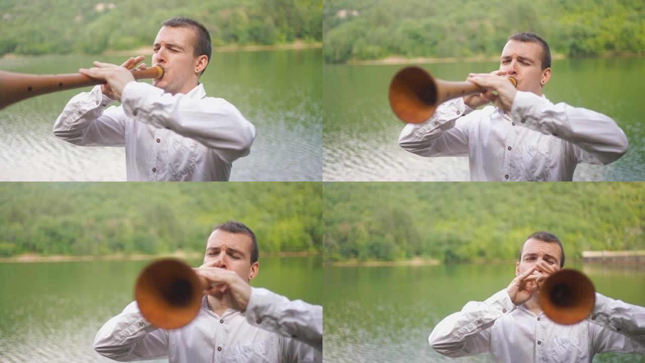 在湖边的男性演奏时，在Zurna传统乐器的洞里看一眼