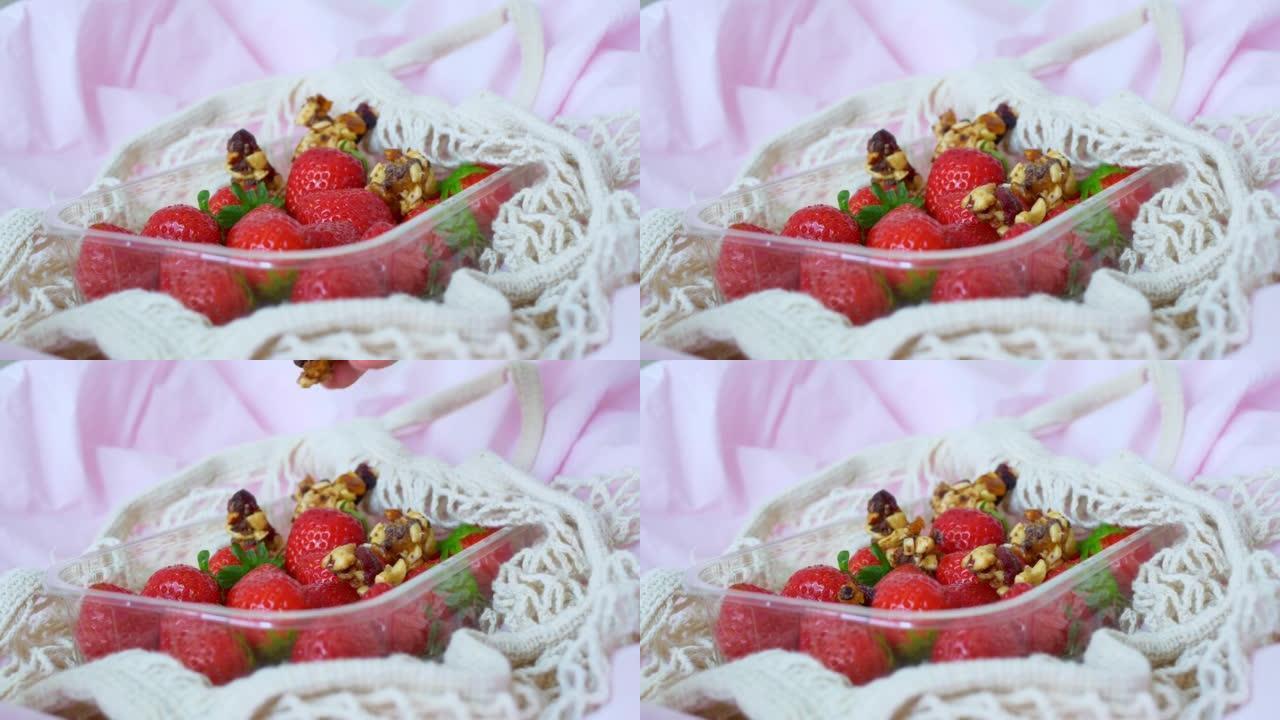 美味的草莓加蔬菜，女性手指将坚果放入蜂蜜和干果中放入草莓篮子中。食品制造商在社交网络中装饰食物以进行
