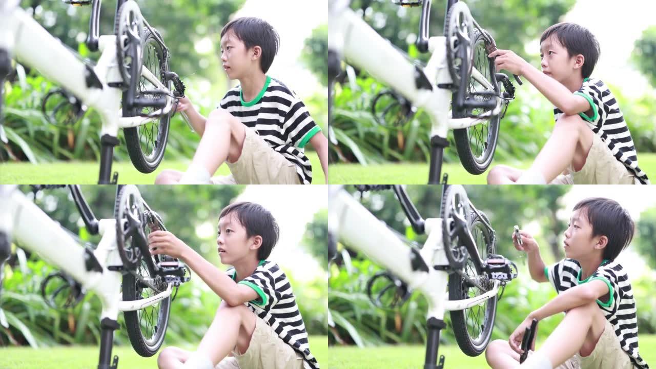 男孩修理自行车小男孩修自行车视频素材特写