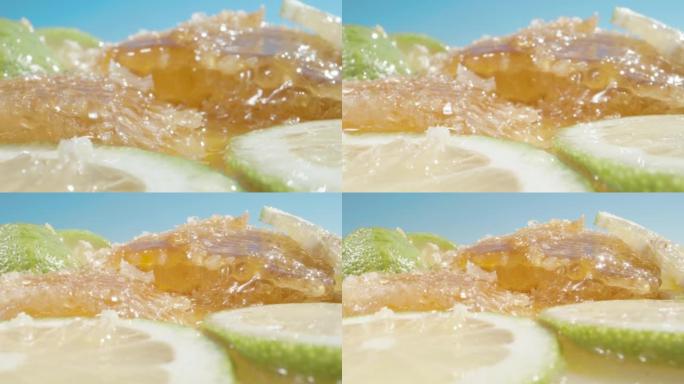 相机在斜坡上平移，上面撒满了蜂蜜和绿色柠檬片。超级宏观幻灯片。