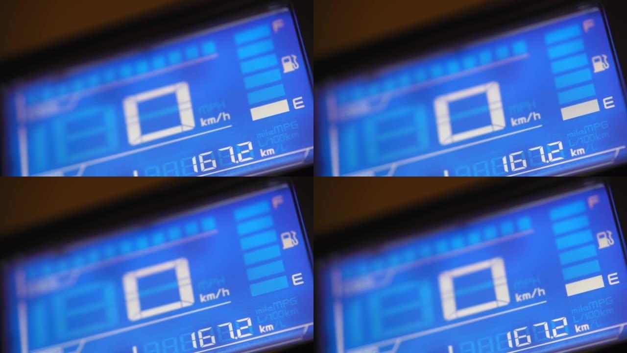 4k镜头关闭蓝色数字仪表显示低燃油警告。