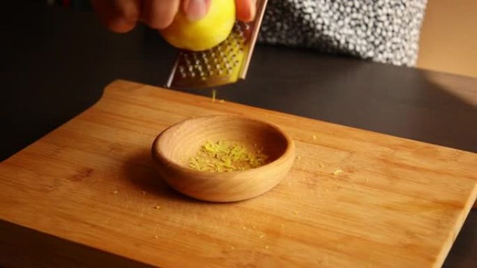 woman hands zesting a lemon close up