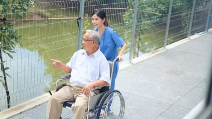 理念疗养院活动带老人坐轮椅在户外放松。