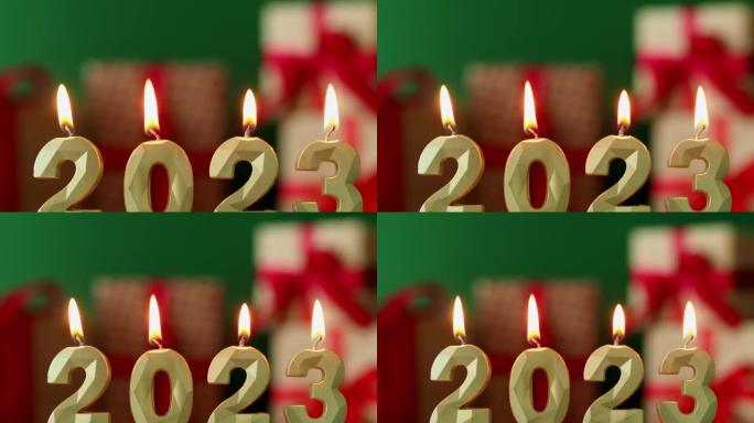 点燃的蜡烛是2023年的象征。圣诞bokeh背景。背景中的加兰。新年快乐，圣诞快乐。蜡烛2023燃烧