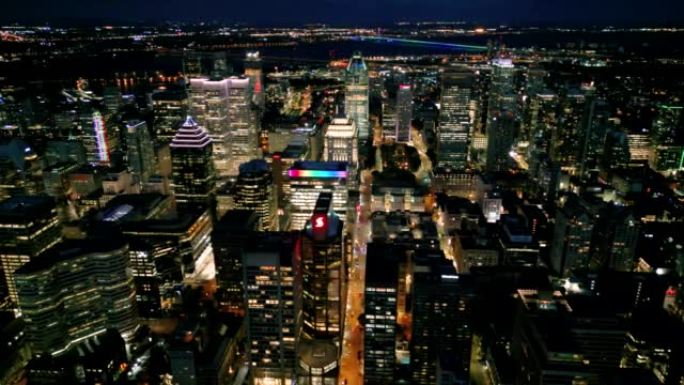4k电影般的城市无人机镜头，拍摄了晚上在魁北克省蒙特利尔市中心的建筑物和摩天大楼的鸟瞰图。
