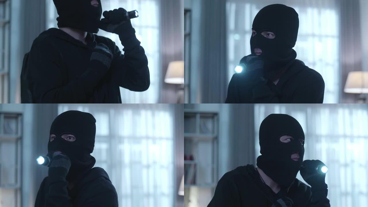 一个拿着手电筒的小偷在某人的房子里行走的特写镜头