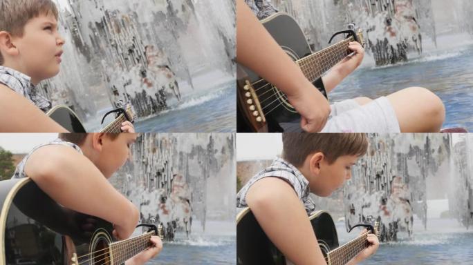 一个穿着格子衬衫的可爱少年在喷泉附近弹木吉他。喷泉附近公园的街头吉他手少年。