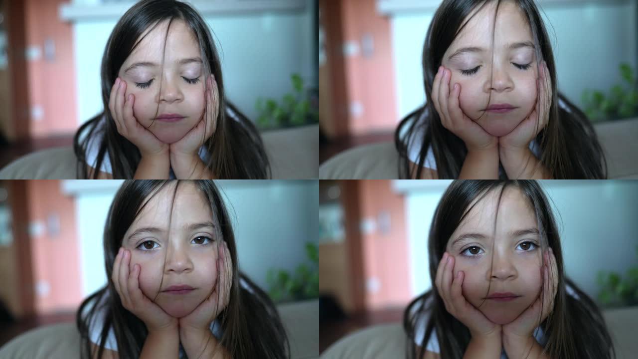 小女孩闭上眼睛看着相机。小小孩的肖像特写脸