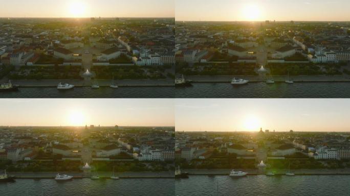皇家阿玛林堡宫的空中下降镜头和弗雷德里克·柯克穹顶的剪影，对抗夕阳。丹麦哥本哈根