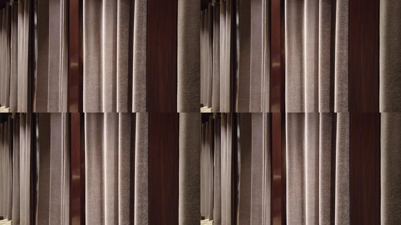 织物窗帘作为背景。服装店更衣室里的棕色窗帘。购物服装概念。