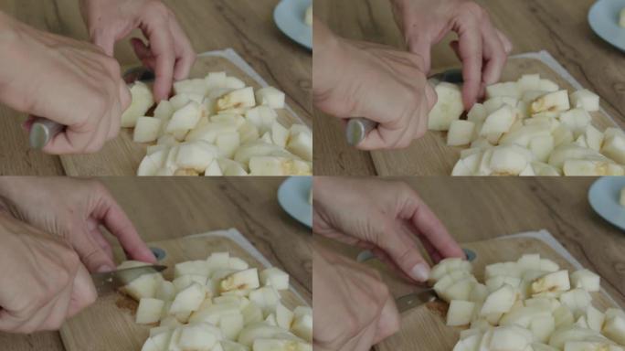 女人把去皮的苹果切成小块。