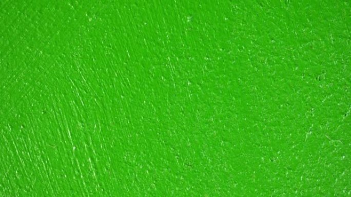 涂漆墙面的幻灯片。Macro dolly纹理绿色表面作为移动背景。