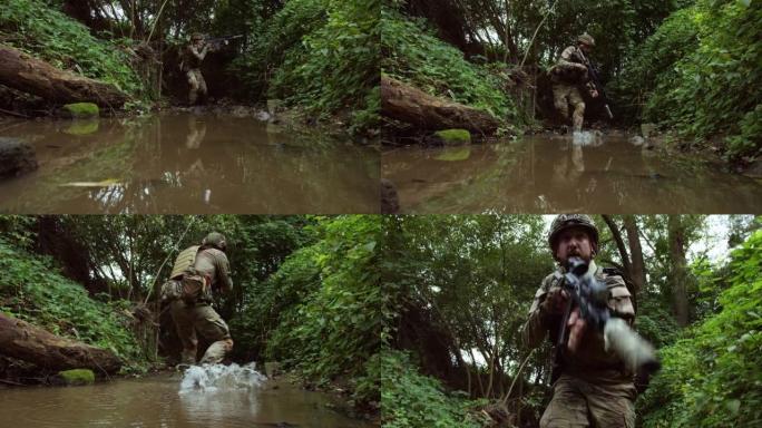 北约士兵在丛林中沿着森林中的河流战术地散步