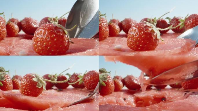 草莓躺在一半的西瓜上，我用勺子挑出果肉。多莉滑块极限特写。老瓦探测器。慢速mo