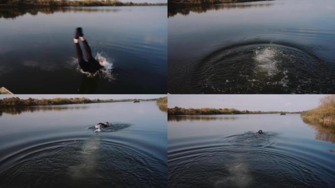 穿着运动服的运动员在湖中跳跃并快速向前游泳