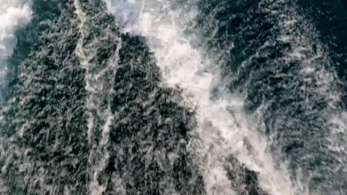 Looking down over the wake left by a  boat traveli