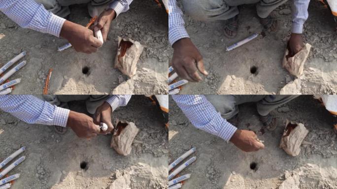 工人在印度建筑工地用保险丝准备炸药的特写录像-带保险丝的炸药