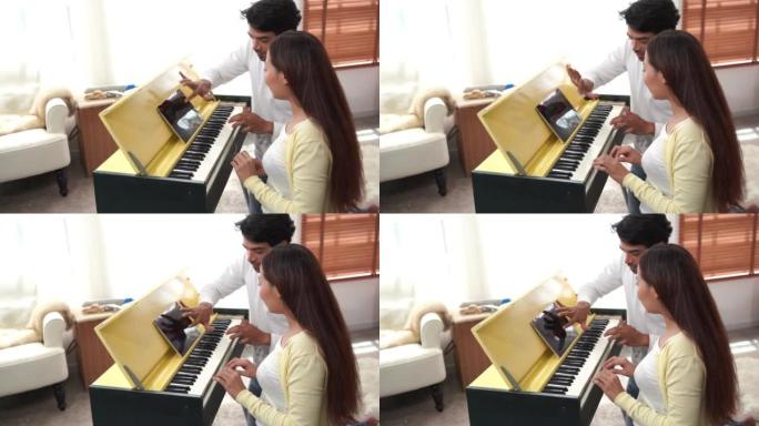 周活动，亚洲夫妇一起弹钢琴，在家娱乐