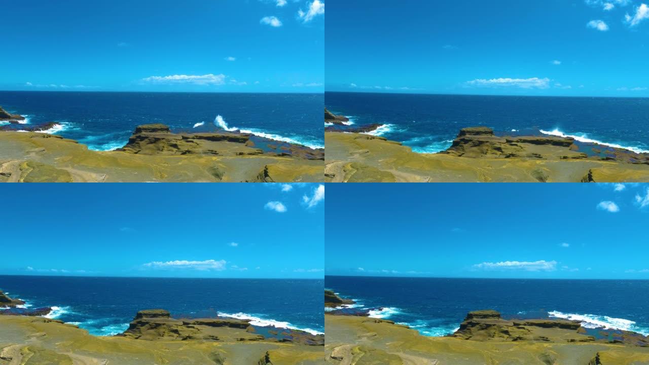 夏威夷海岸线上有悬崖的落基山脉。蓝色的海浪以慢动作撞击山岩。瓦胡岛檀香山的悬崖到海洋。夏威夷的拉奈了