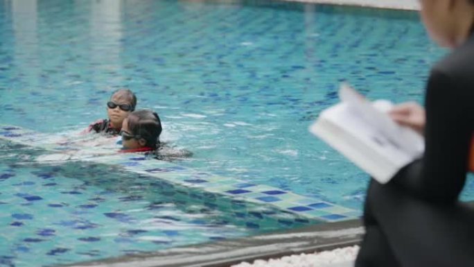 Two asian siblings girl playing water together in 