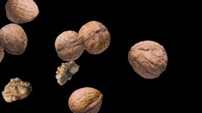 Three walnuts and two shelled walnuts rotate slowl