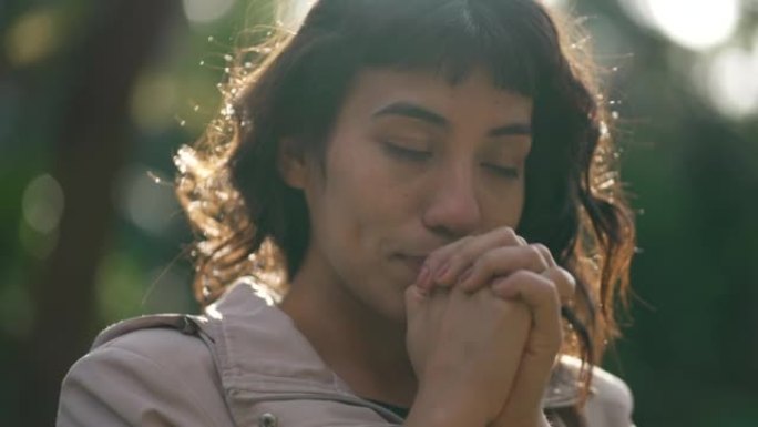 Person closing eyes in meditation prayer standing 