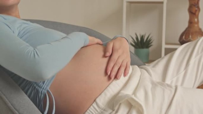 Pregnant Woman Stroking Her Belly Tenderly