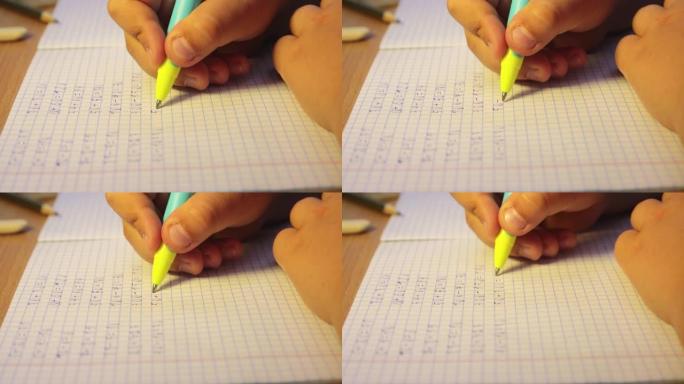 学生的双手特写在笔记本上写数学示例。
