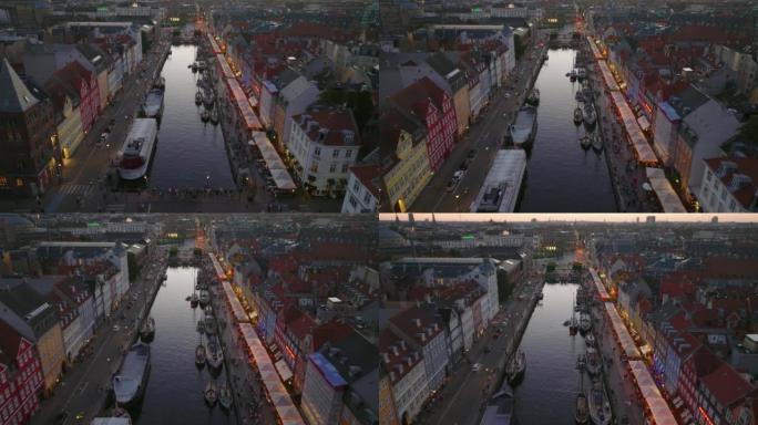 现代帆船在运河中平静水面的鸟瞰图。晚上在著名的旅游街新港。丹麦哥本哈根
