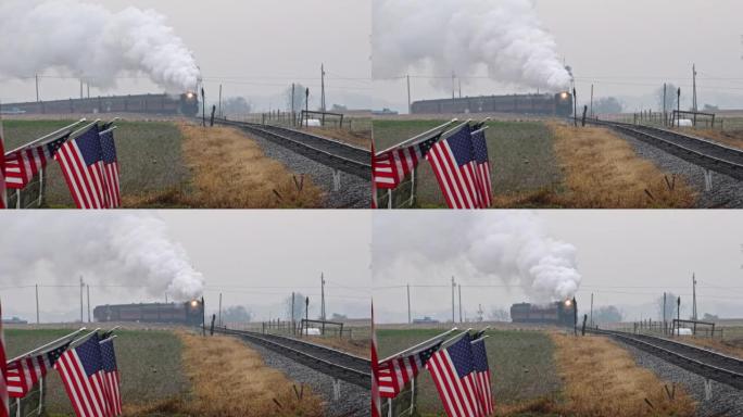 一列蒸汽旅客列车绕过弯道，吹着浓烟，在农田的篱笆上轻轻挥舞着美国国旗的长景