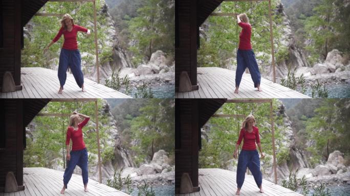 湖边的瑜伽-精神振奋的女人闭着眼睛在现场摇摆